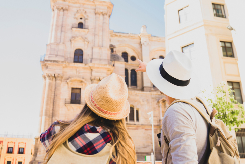 Two tourists looking at an ancient infrastructure.