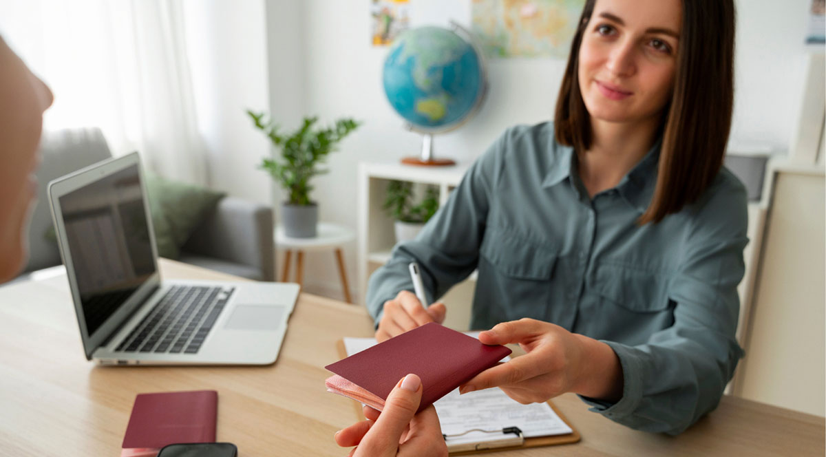 A woman handing over a visa to the person in front of her.