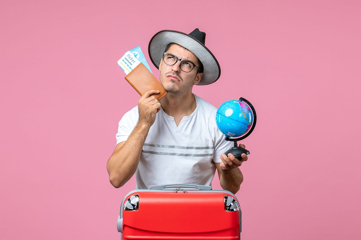 A man with his luggage, passport and plane ticket.