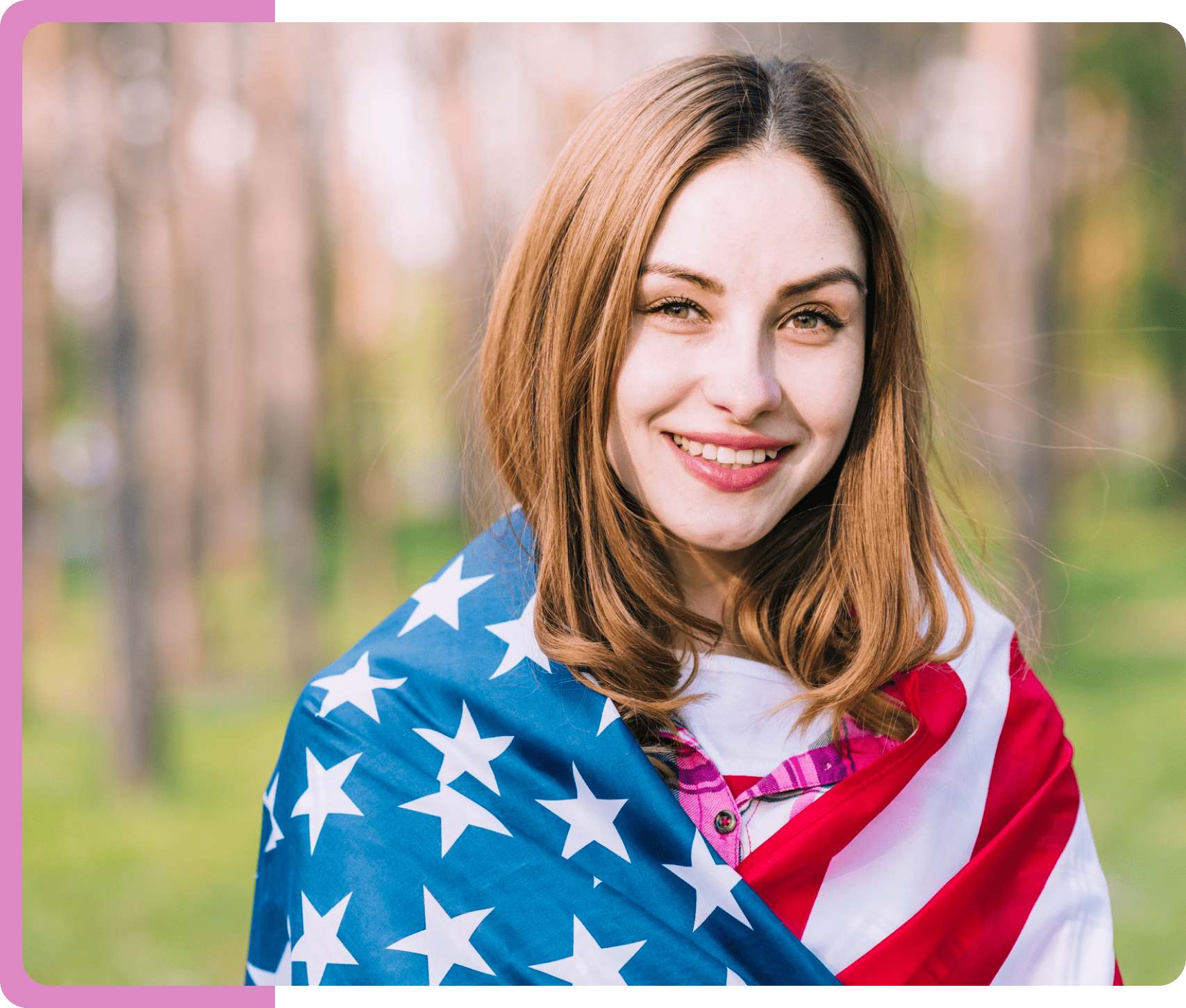 A blonde American lady with an American flag wrapped around her shoulders.