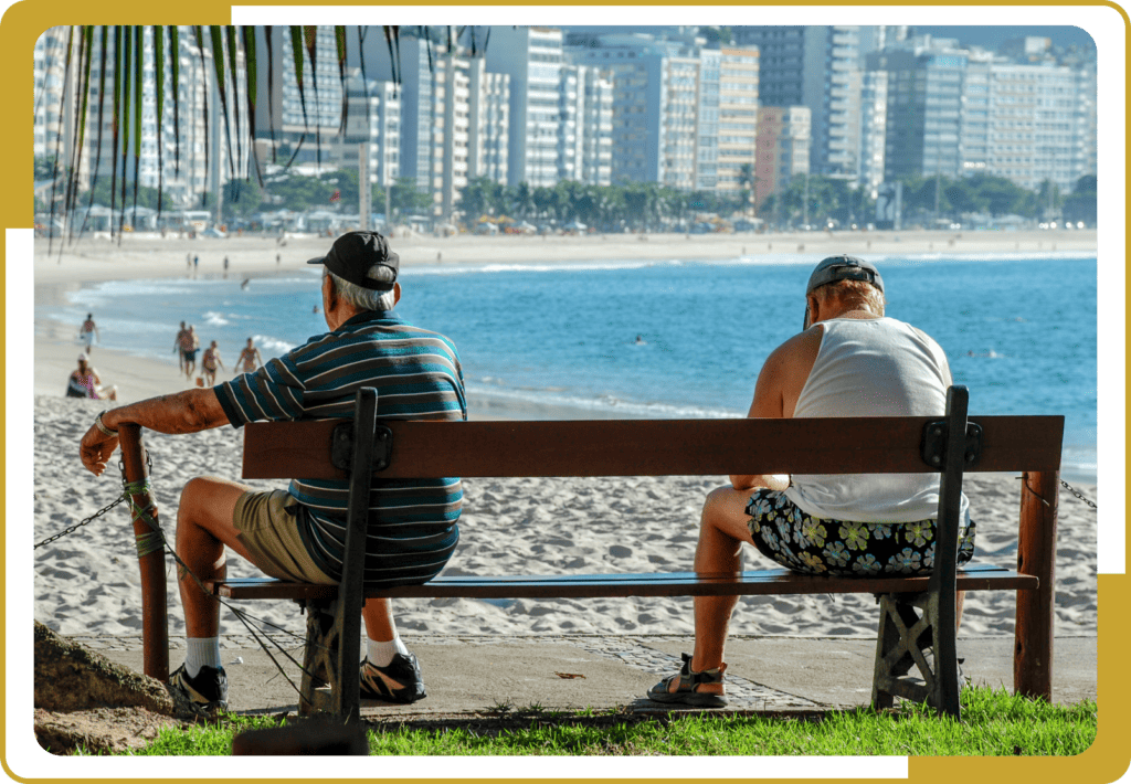 Old men staring at the wonderful view of the beach.