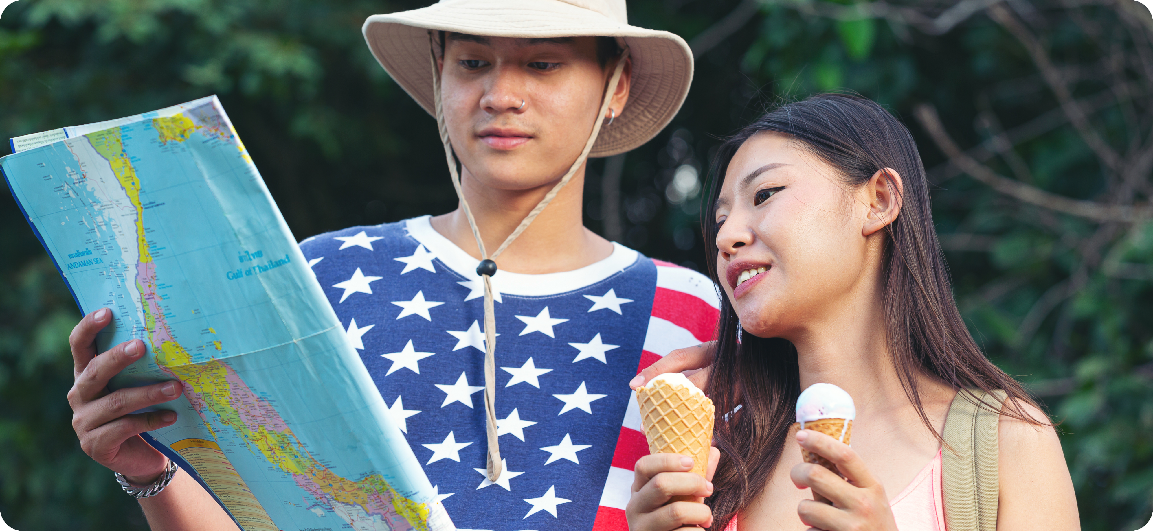 Two young tourists, holding a map in an outdoor setting