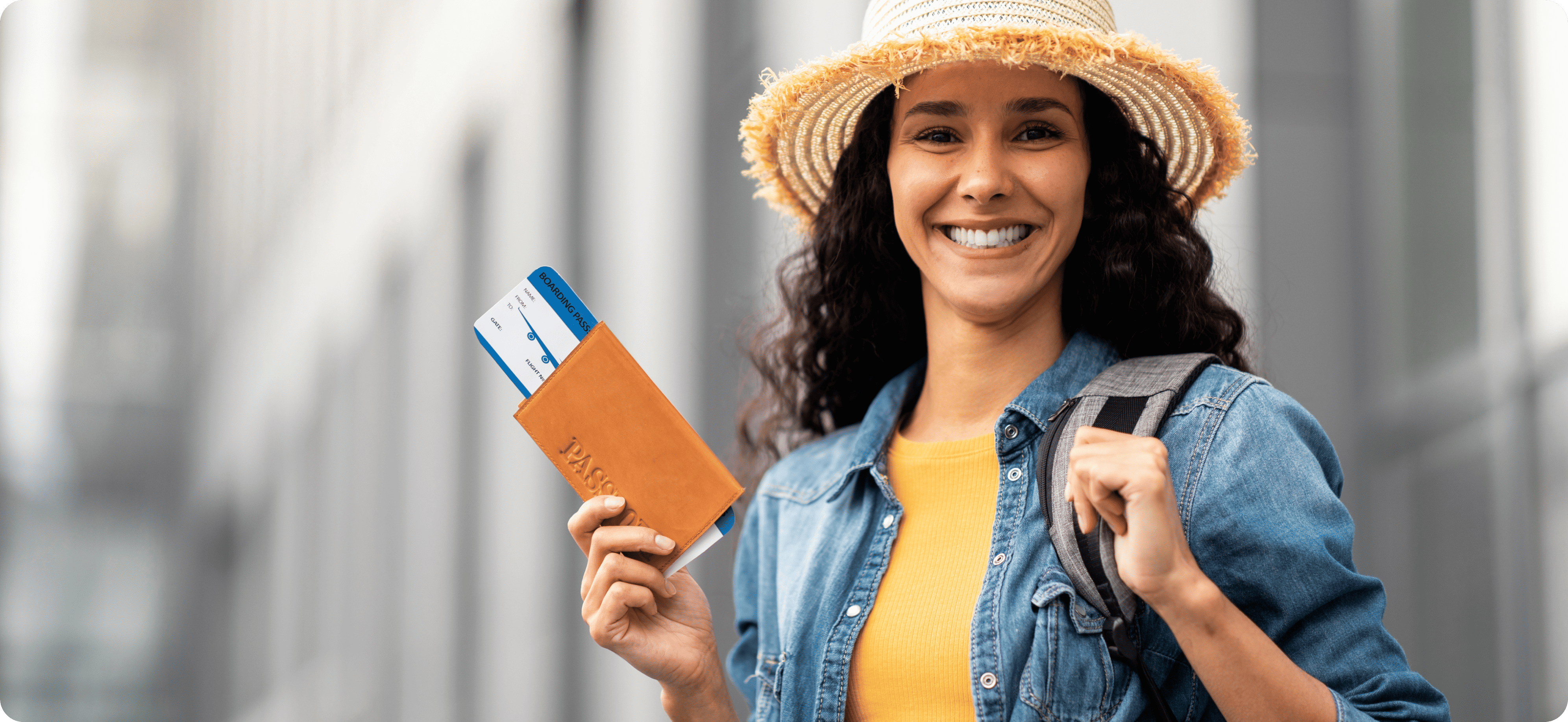 A young female tourist holding her passport and plane ticket