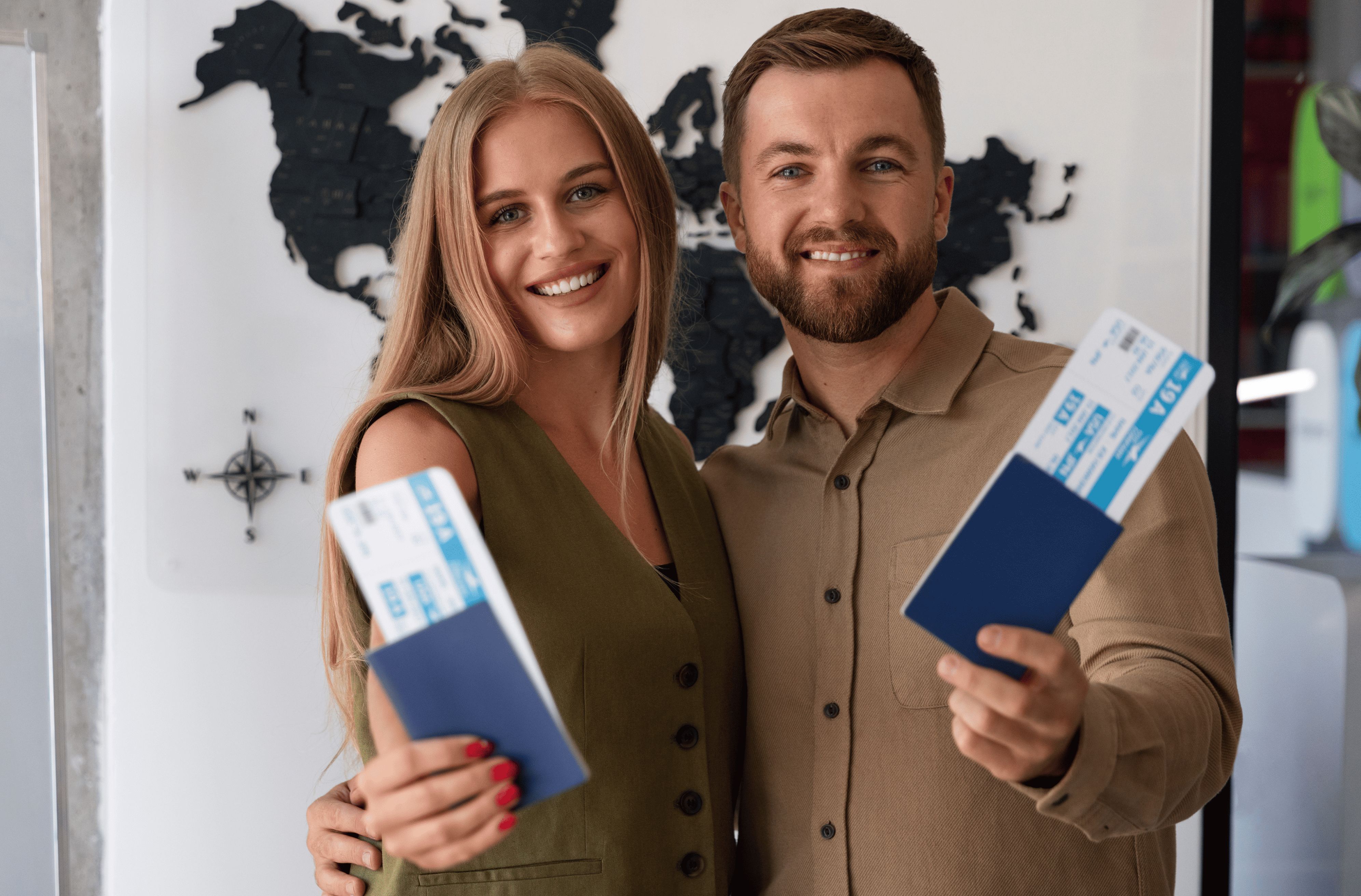 A blonde woman and a bearded man holding the passports and plane tickets
