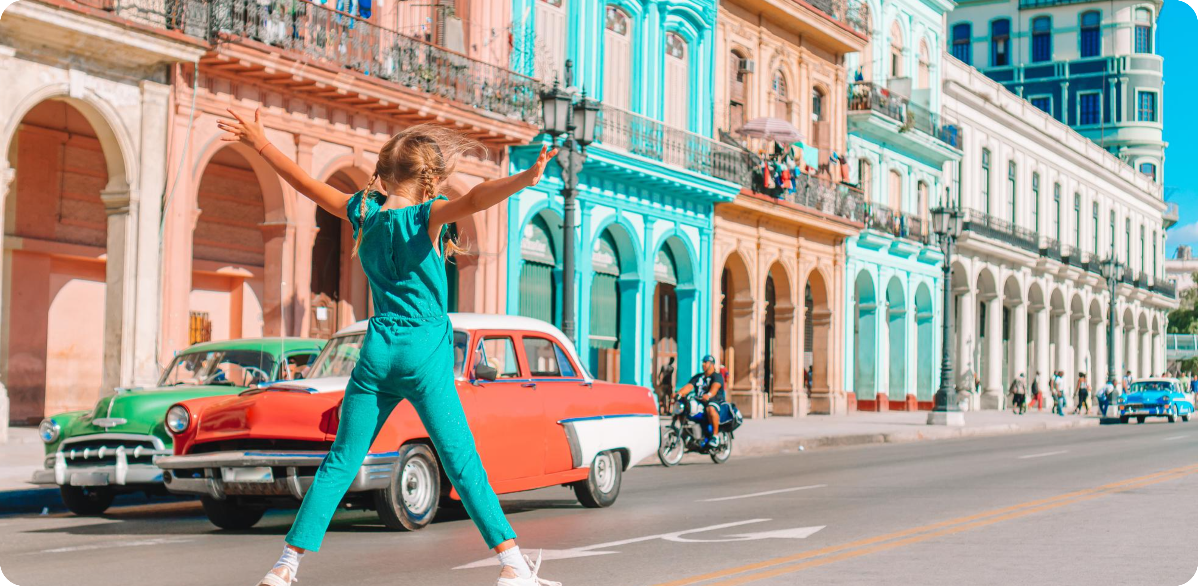 A blonde little girl playing in the streets with colorful buildings
